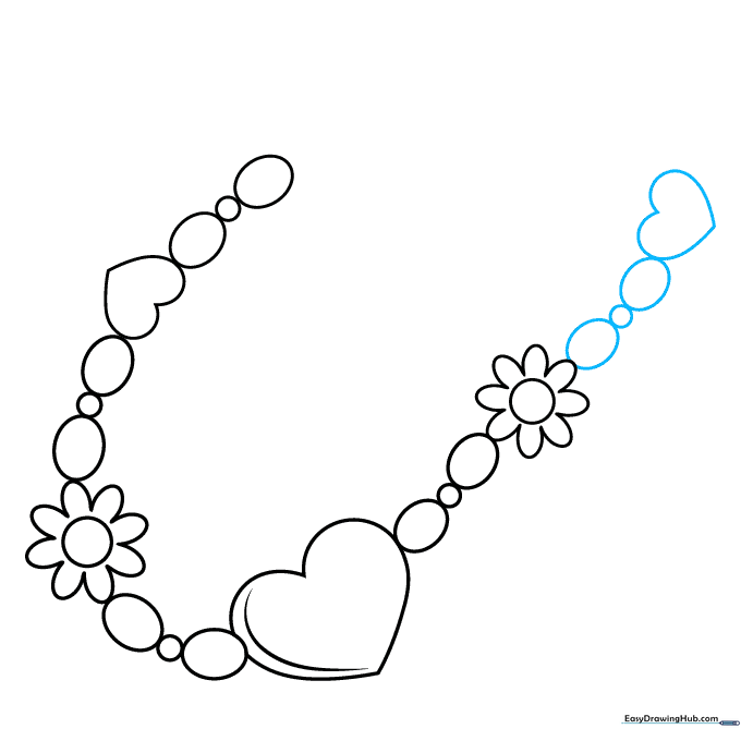 Adding a final small heart charm to the end of the bracelet chain.