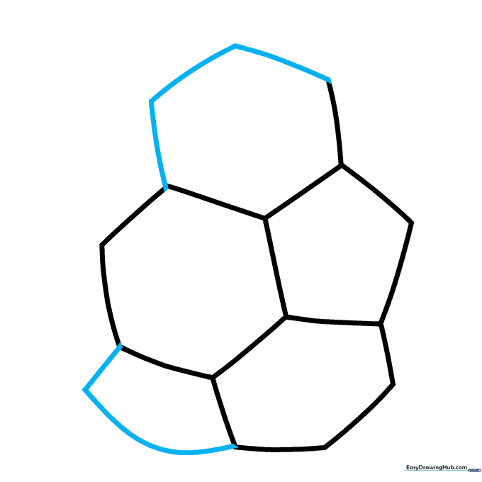 Drawing curved lines to form the base of the soccer ball's geometric pattern.
