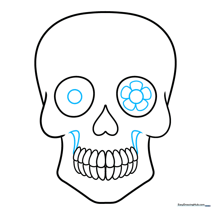 Skull drawing showing the addition of mouth lines and a flower petal pattern inside one eye socket.