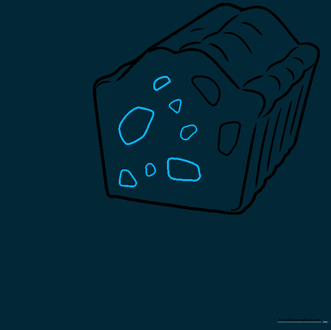 Adding more candied fruit shapes to the fruitcake interior.
