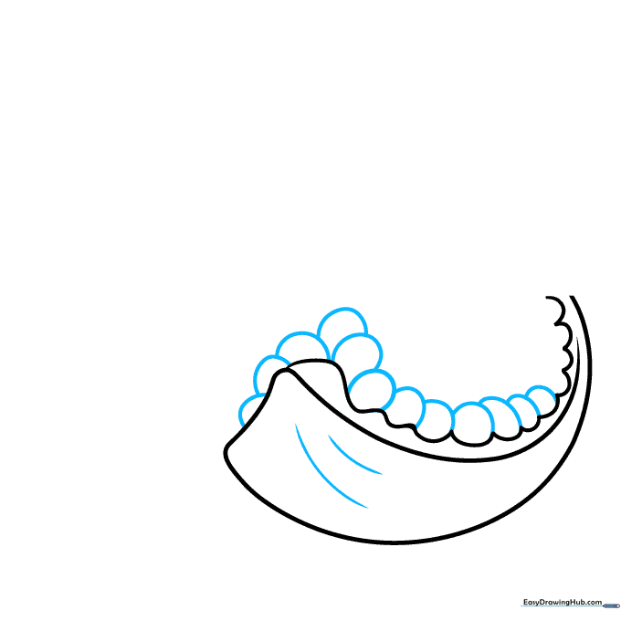 Drawing the first cluster of oval-shaped pomegranate seeds inside the slice.