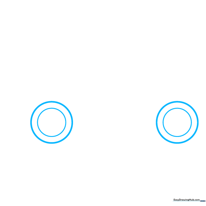 Two circles drawn on paper to represent the front and back wheels of a sports car.