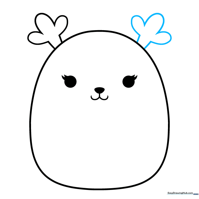 Adding the second antler to the opposite side of the Squishmallow head.
