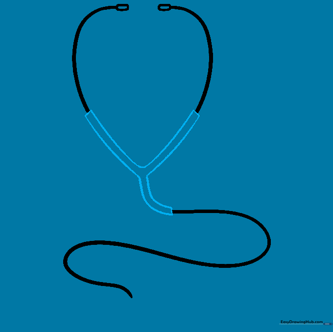 A Y-shaped junction connecting the two ear tubes to the main chest piece tube.