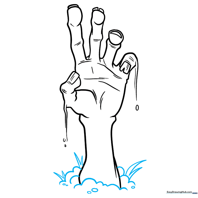 Adding clumps of dirt and earth around the base of the zombie hand.