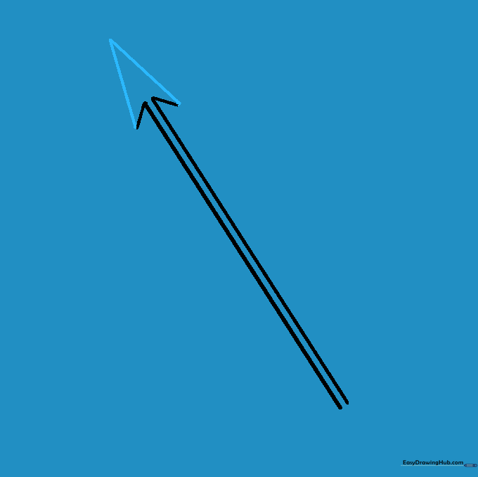 A completed triangular arrowhead sitting on top of the shaft.