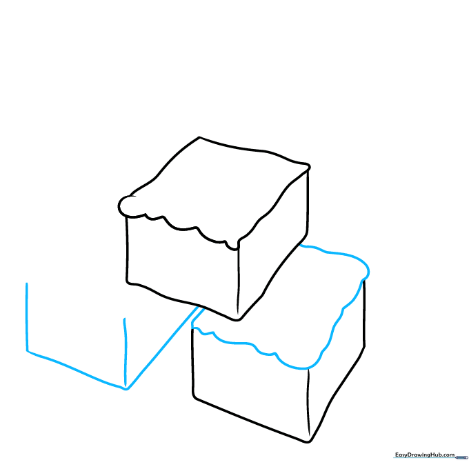 Adding wavy icing lines to the second brownie and starting the third cube.