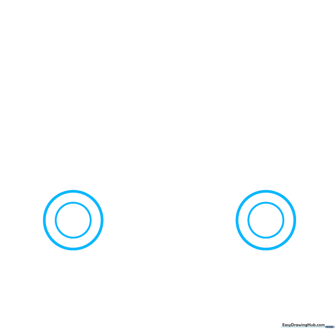 Two circles drawn on paper representing the wheels of a car, shown in a light pencil sketch.
