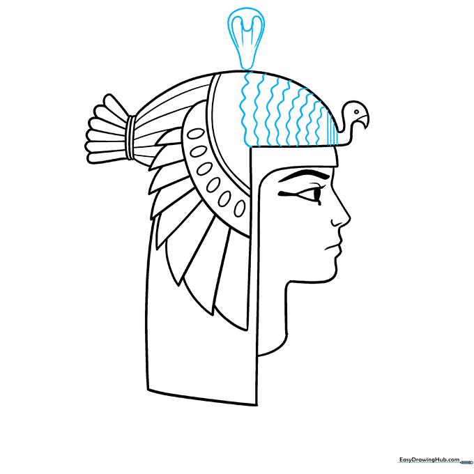 Drawing the cobra symbol on the front of the headdress.