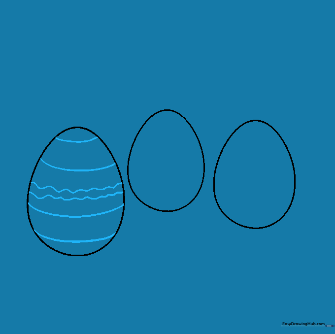 The first egg decorated with horizontal stripes and a central wavy line.
