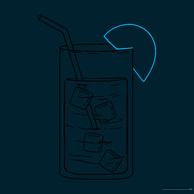 A lemon slice garnish being drawn on the rim of the glass.