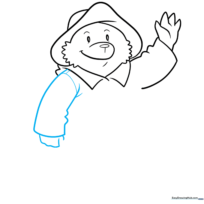 Paddington's hand grasping the handle of his suitcase.